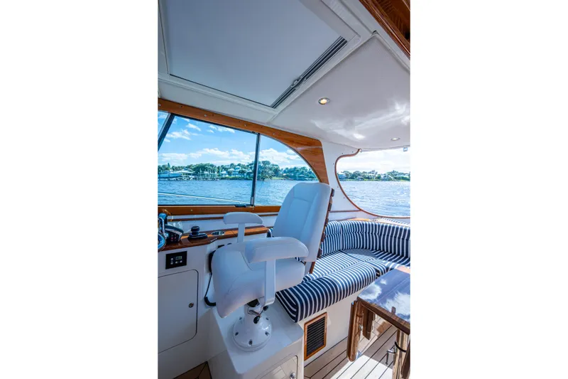 Slide: The Image of Interior of 2024 Hinckley 35 yacht with striped seating and water view. - 38