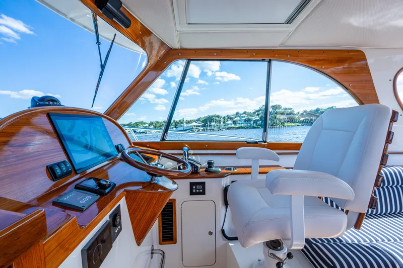 Slide: The Image of 2024 Hinckley 35 yacht interior with modern helm and luxurious seating. - 39