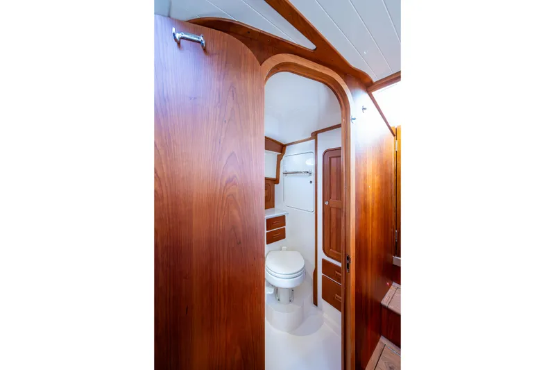 Slide: The Image of 2024 Hinckley 35 yacht bathroom with elegant wood finish and modern amenities. - 47