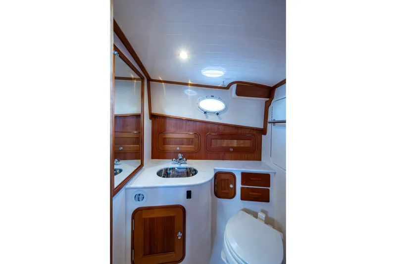 Slide: The Image of Luxurious 2024 Hinckley 35 yacht bathroom with elegant wood accents and modern fixtures. - 48