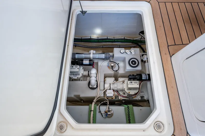 Slide: The Image of 2024 Hinckley 35 yacht engine compartment with visible mechanical components and wiring. - 50