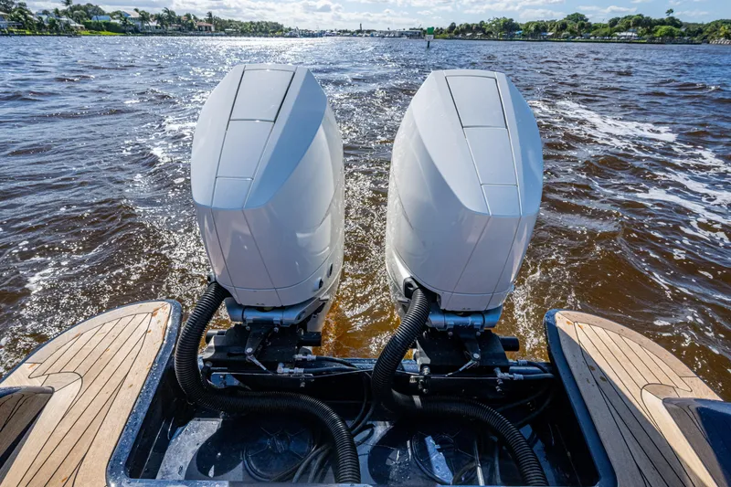 Slide: The Image of Twin outboard engines on a 2024 Hinckley 35 boat cruising through water. - 51