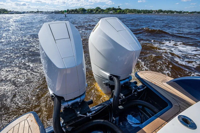 Slide: The Image of 2024 Hinckley 35 boat with dual outboard motors on a sunny day. - 52