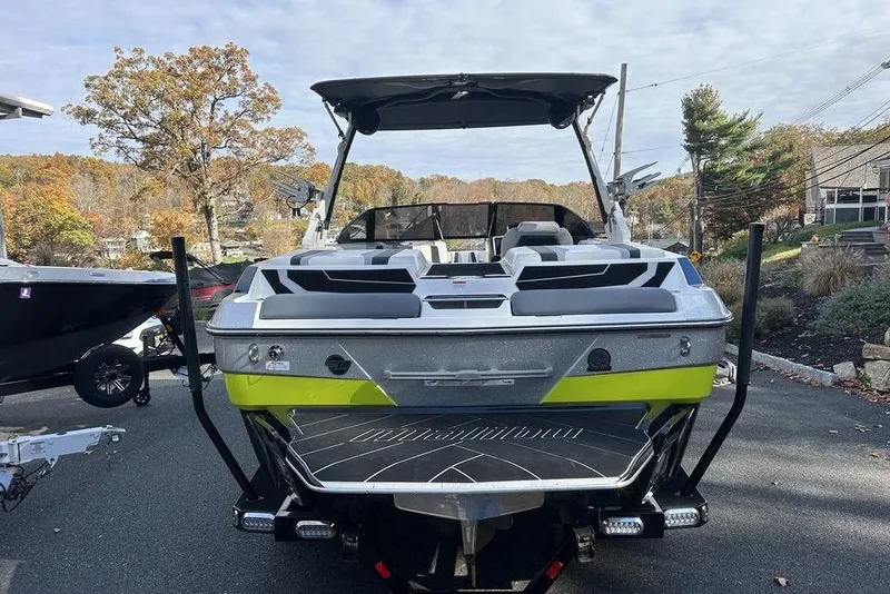 Slide: The Image of 2024 Malibu Wakesetter 22 LSV boat, rear view, parked outdoors, showcasing sleek design. - 12