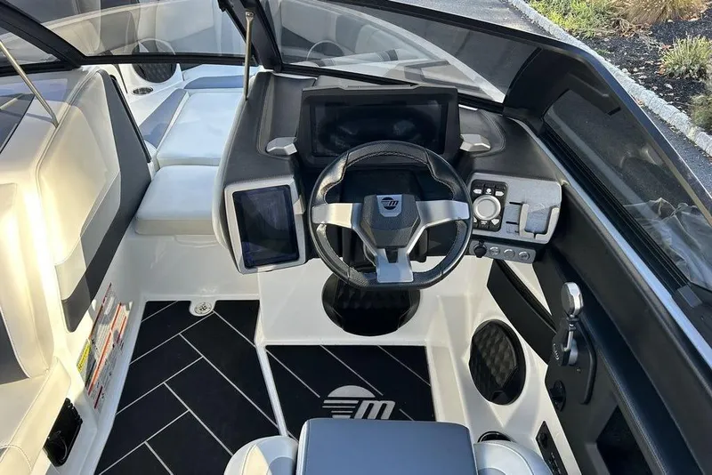 Slide: The Image of 2024 Malibu Wakesetter 22 LSV cockpit with modern steering and control panel. - 13