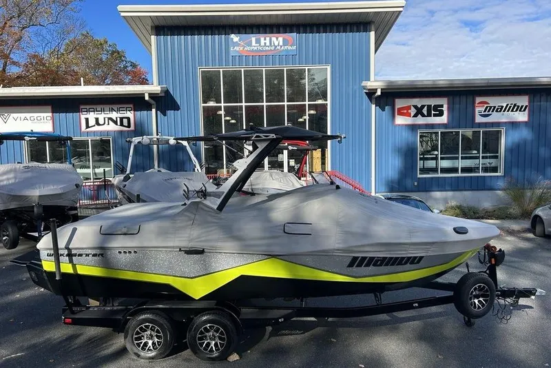 Slide: The Image of 2024 Malibu Wakesetter 22 LSV boat covered, parked outside dealership. - 14