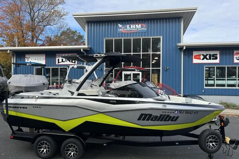 Slide: The Image of 2024 Malibu Wakesetter 22 LSV boat on trailer outside dealership. - 3