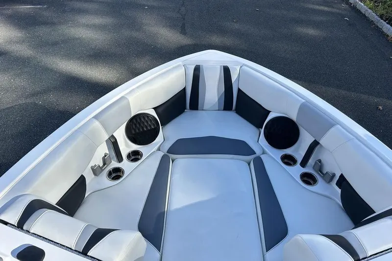 Slide: The Image of 2024 Malibu Wakesetter 22 LSV boat interior with cushioned seating and cup holders. - 8