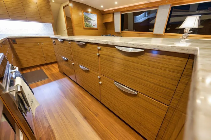 Slide: The Image of Luxurious yacht kitchen with wooden cabinetry, marble countertops, and modern lighting, Weaver custom 2012. - 13