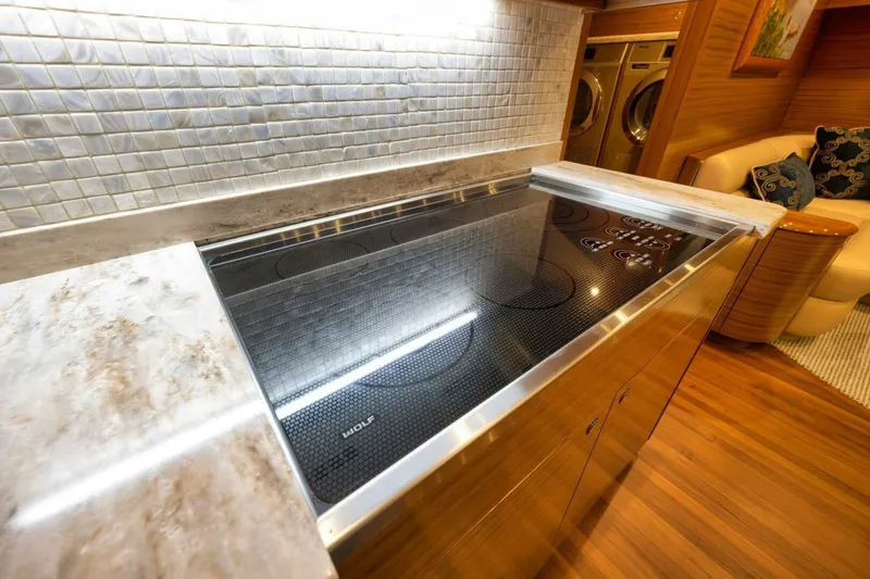 Slide: The Image of Modern kitchen with Wolf cooktop, marble countertops, and mosaic backsplash in Weaver custom 2012 model. - 14