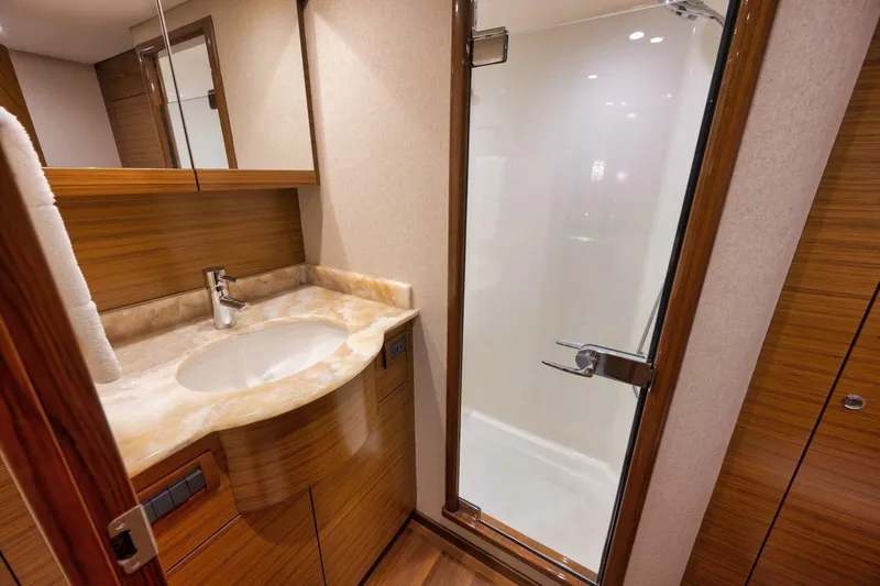 Slide: The Image of Luxurious yacht bathroom with wooden cabinetry, marble sink, and glass shower door, Weaver custom 2012. - 18