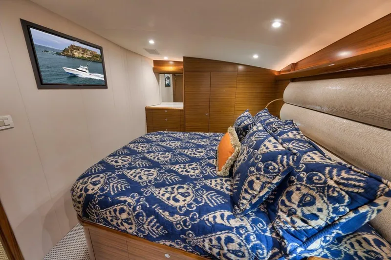 Slide: The Image of Luxurious yacht bedroom with patterned bedding, wooden accents, and framed ocean view. Weaver custom 2012. - 20