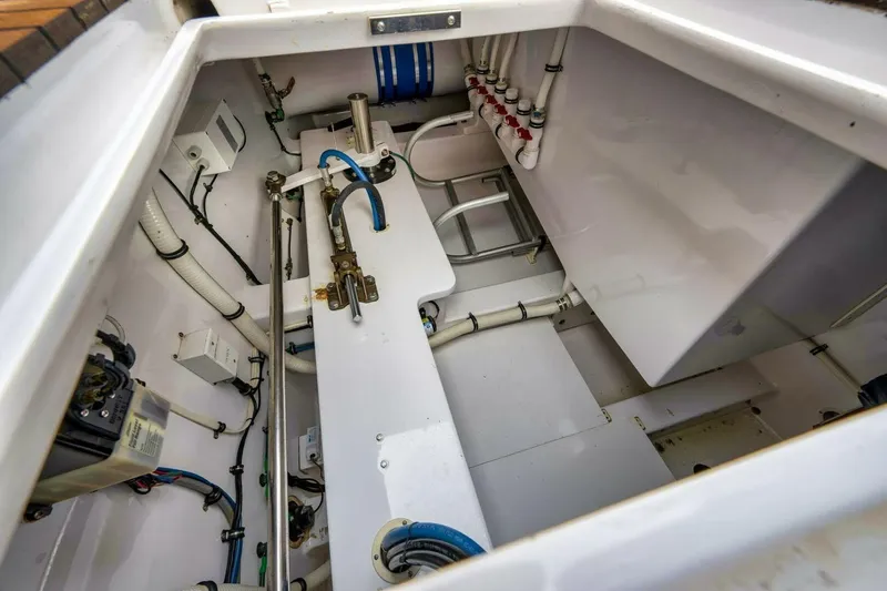 Slide: The Image of Engine compartment of a 2012 Weaver custom boat, showcasing pipes and mechanical components. - 38