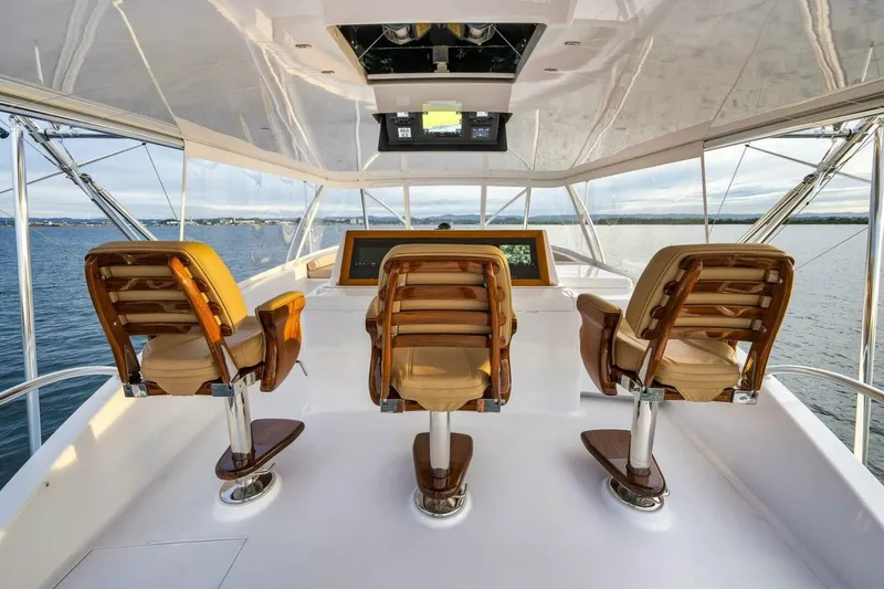 Slide: The Image of Luxurious Weaver custom yacht helm with three elegant captain chairs, overlooking serene waters. - 41