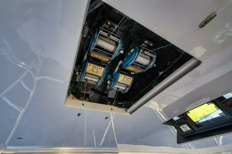 Slide: The Image of Ceiling-mounted fishing reels and electronic display on a 2012 Weaver custom boat. - 43