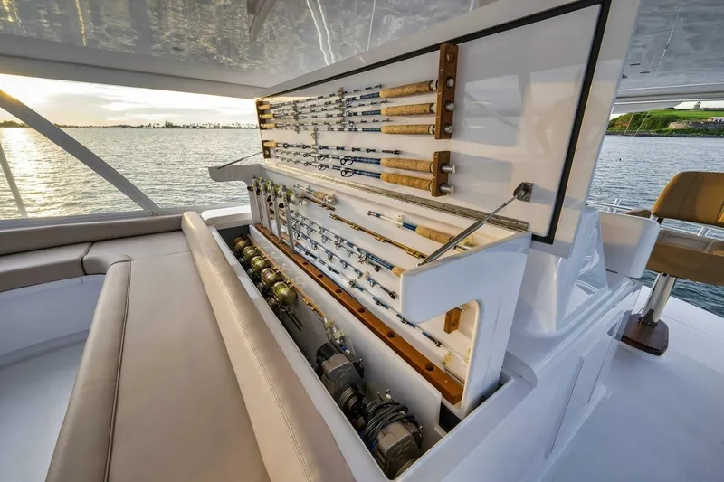Slide: The Image of Luxury yacht with custom fishing rod storage, Weaver model, 2012, on serene water backdrop. - 45