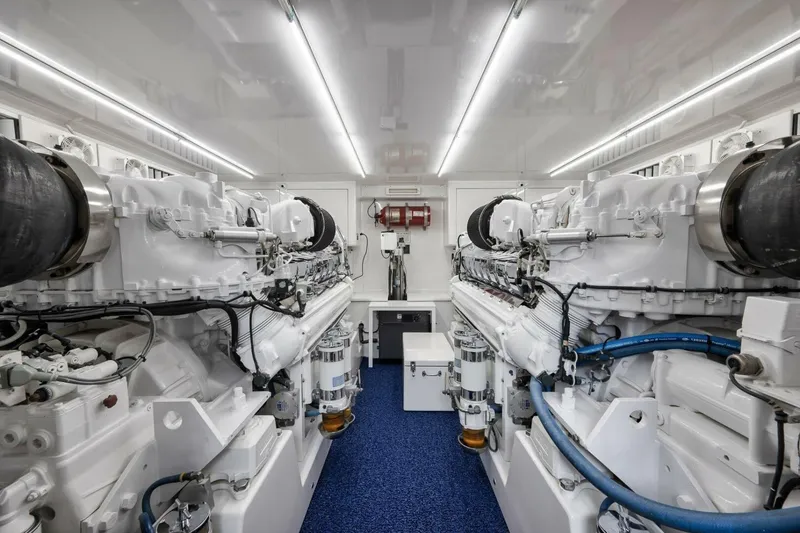 Slide: The Image of Engine room of a 2012 Weaver custom model, featuring dual white engines and blue flooring. - 46