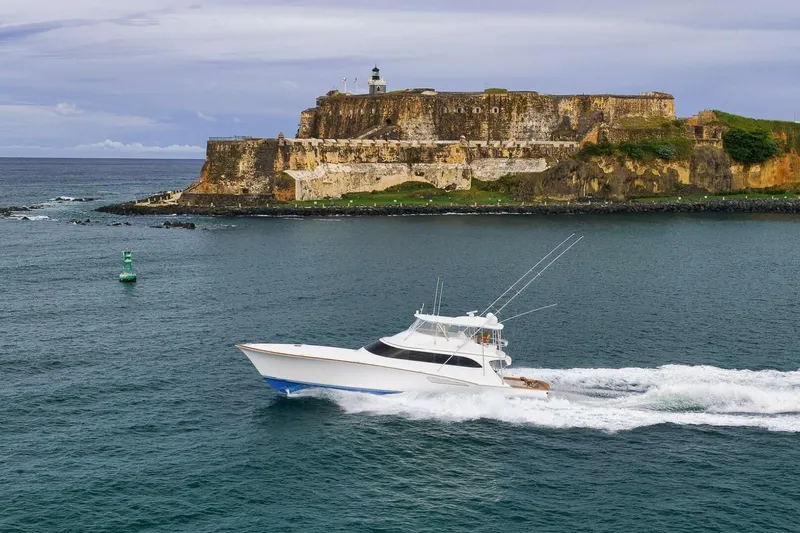 Slide: The Image of Sportfishing boat cruising near historic fort, Weaver custom model, 2012, in scenic coastal waters. - 5