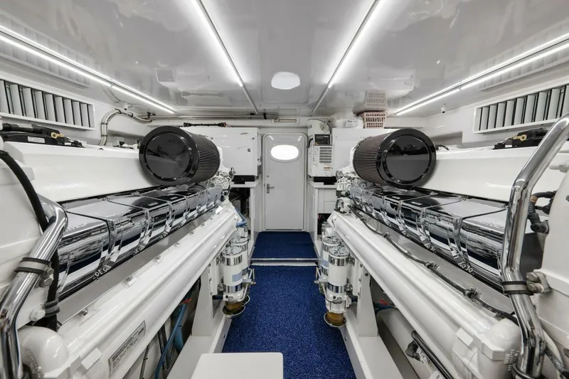 Slide: The Image of Engine room of a 2012 Weaver custom boat, featuring dual engines and sleek design. - 50