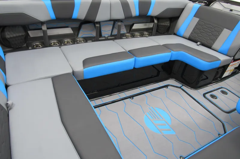 Slide: The Image of 2026 Malibu Wakesetter 22 MXZ interior with blue and gray seating and stylish flooring. - 5