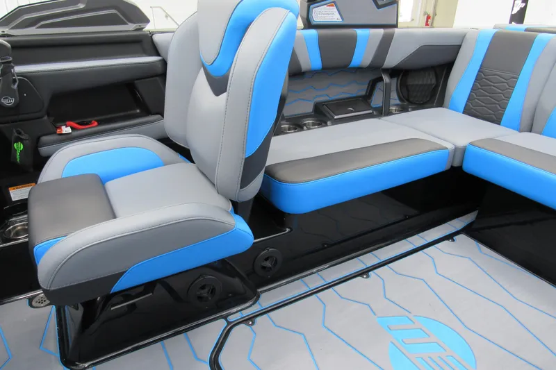 Slide: The Image of 2026 Malibu Wakesetter 22 MXZ interior with blue and gray seating, modern design. - 6