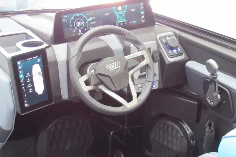 Slide: The Image of 2026 Malibu Wakesetter 22 MXZ dashboard with modern steering and digital displays. - 7