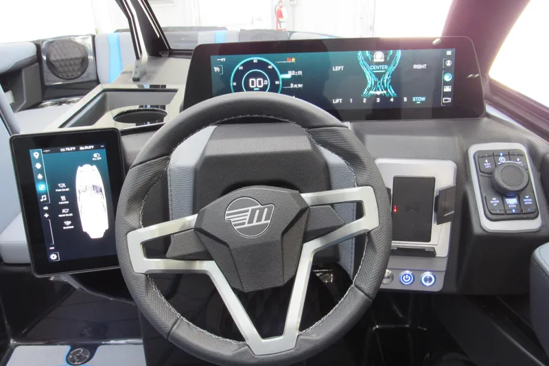 Slide: The Image of 2026 Malibu Wakesetter 22 MXZ dashboard with advanced digital controls and steering wheel. - 8