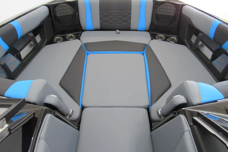 Slide: The Image of 2026 Malibu Wakesetter 22 MXZ interior with gray and blue seating, cup holders, and modern design. - 9