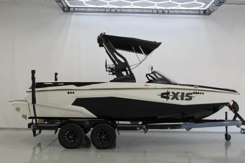 The Image of 2026 Axis A200 boat on trailer in showroom with modern lighting. - 0