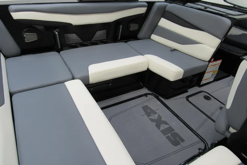 Slide: The Image of 2026 Axis A200 boat interior with gray and white cushioned seating. - 6