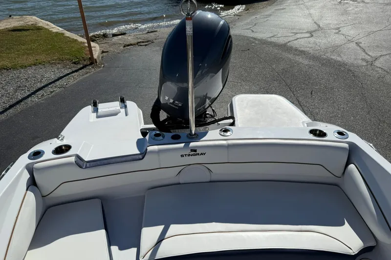 Slide: The Image of 2026 Stingray 191 DC boat with Yamaha 115 engine at a lakeside launch. - 10