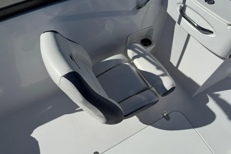 Slide: The Image of 2026 Stingray 191 DC boat interior with white and navy seating. - 13