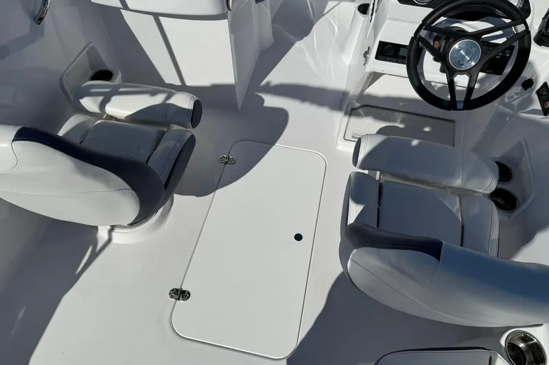 Slide: The Image of 2026 Stingray 191 DC boat interior with white seating and steering wheel. - 14