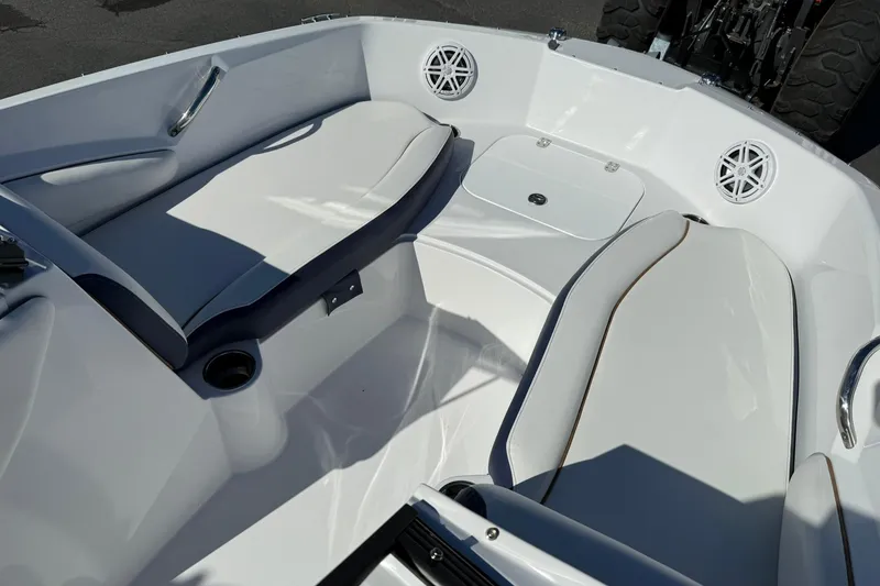 Slide: The Image of 2026 Stingray 191 DC boat interior with white seating and cup holders. - 17