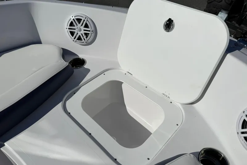 Slide: The Image of 2026 Stingray 191 DC boat interior with open storage compartment and speaker. - 18