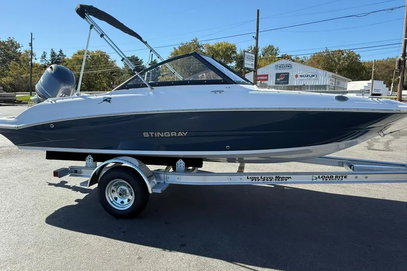 Slide: The Image of 2026 Stingray 191 DC boat on trailer, parked outdoors at marina. - 5