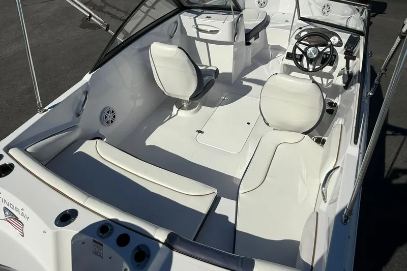 Slide: The Image of 2026 Stingray 191 DC boat interior with white seating and modern dashboard. - 8