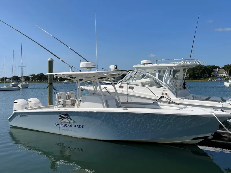 The Image of 2013 Jupiter 30 FS boat docked in a marina under clear blue skies. - 0