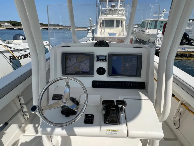 Slide: The Image of Helm of 2013 Jupiter 30 FS boat with navigation screens and steering wheel. - 1