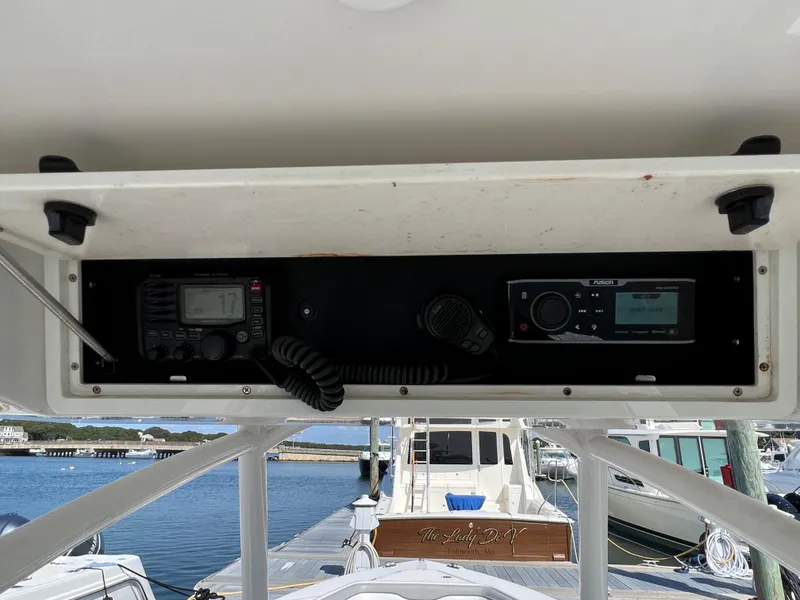 Slide: The Image of 2013 Jupiter 30 FS boat console with radio and navigation equipment, docked at marina. - 12