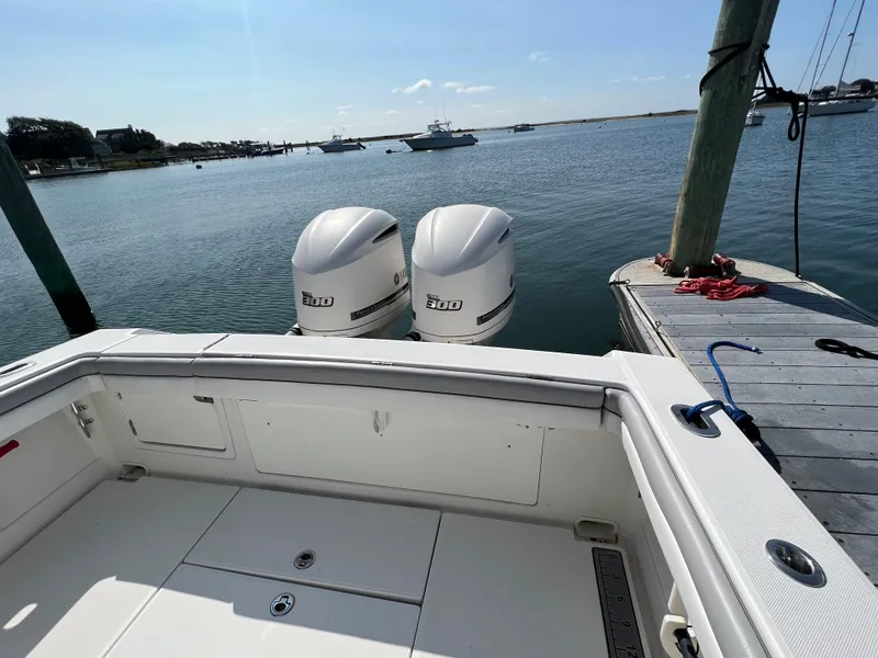 Slide: The Image of 2013 Jupiter 30 FS boat with twin engines docked by the water. - 13