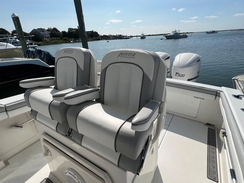 Slide: The Image of 2013 Jupiter 30 FS boat with dual seats, docked by the water. - 14