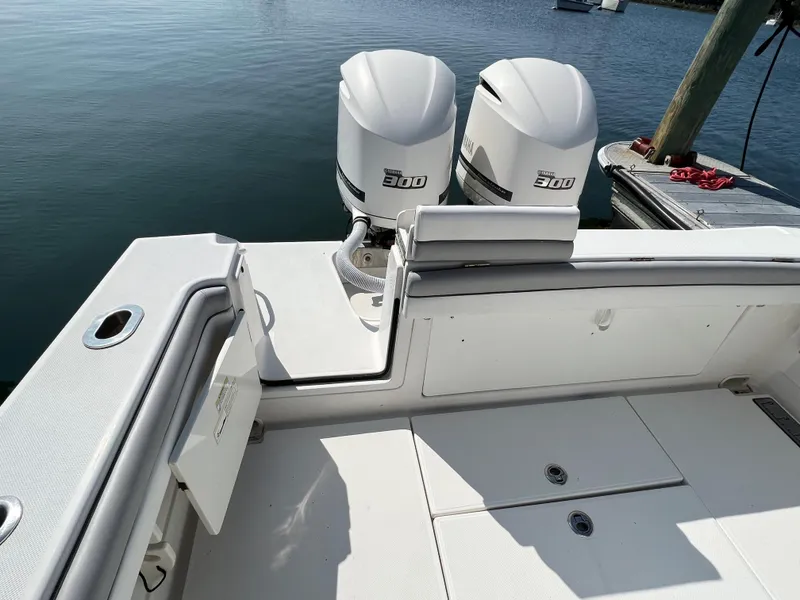 Slide: The Image of 2013 Jupiter 30 FS boat with twin outboard engines on calm water. - 16