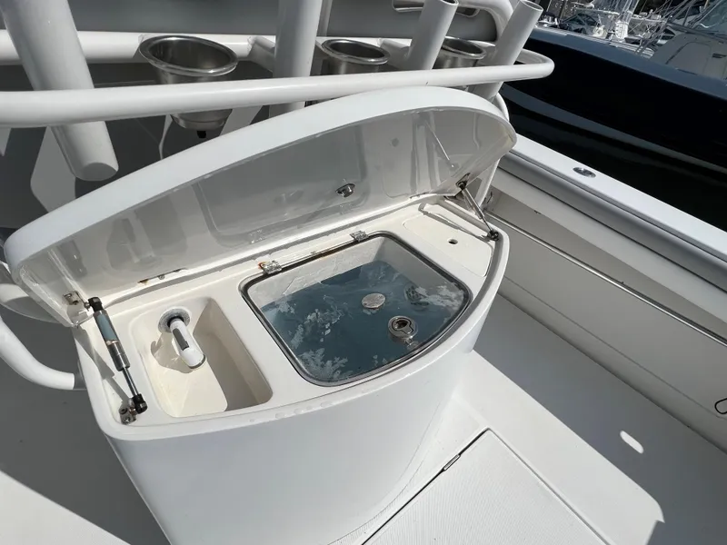 Slide: The Image of 2013 Jupiter 30 FS boat with open livewell and rod holders. - 18
