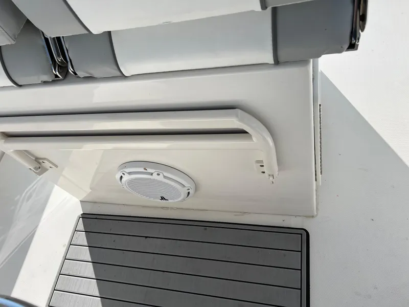 Slide: The Image of Interior view of a 2013 Jupiter 30 FS boat, featuring seating and a speaker. - 20