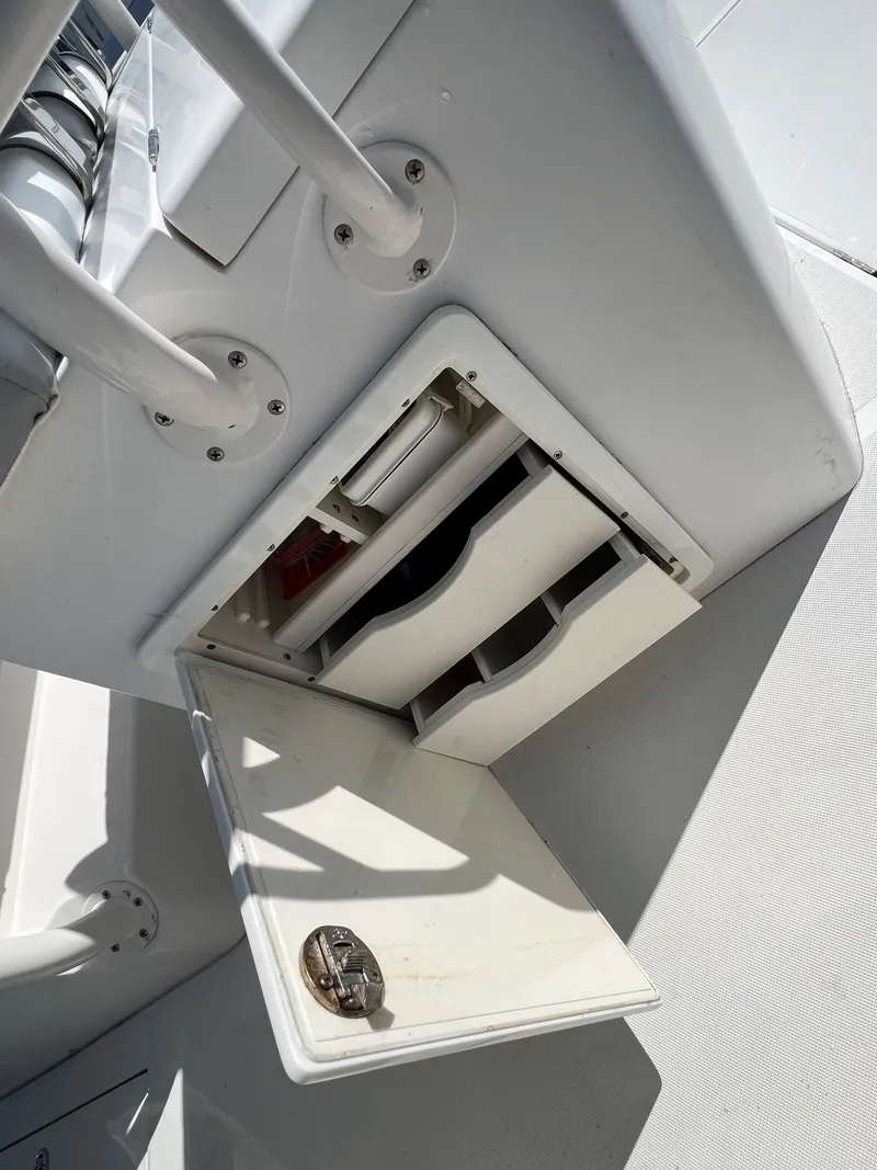 Slide: The Image of 2013 Jupiter 30 FS boat storage compartment with open hatch and visible drawers. - 21