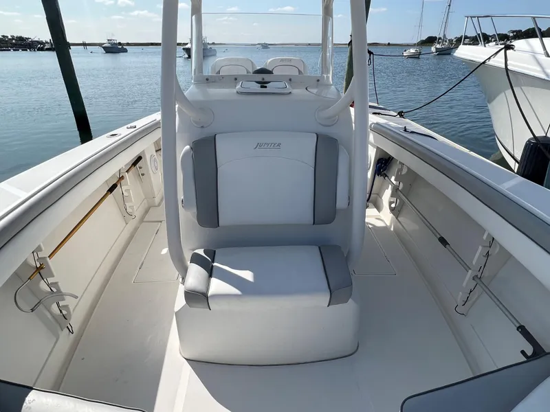 Slide: The Image of 2013 Jupiter 30 FS boat interior with seating, docked on a sunny day. - 25