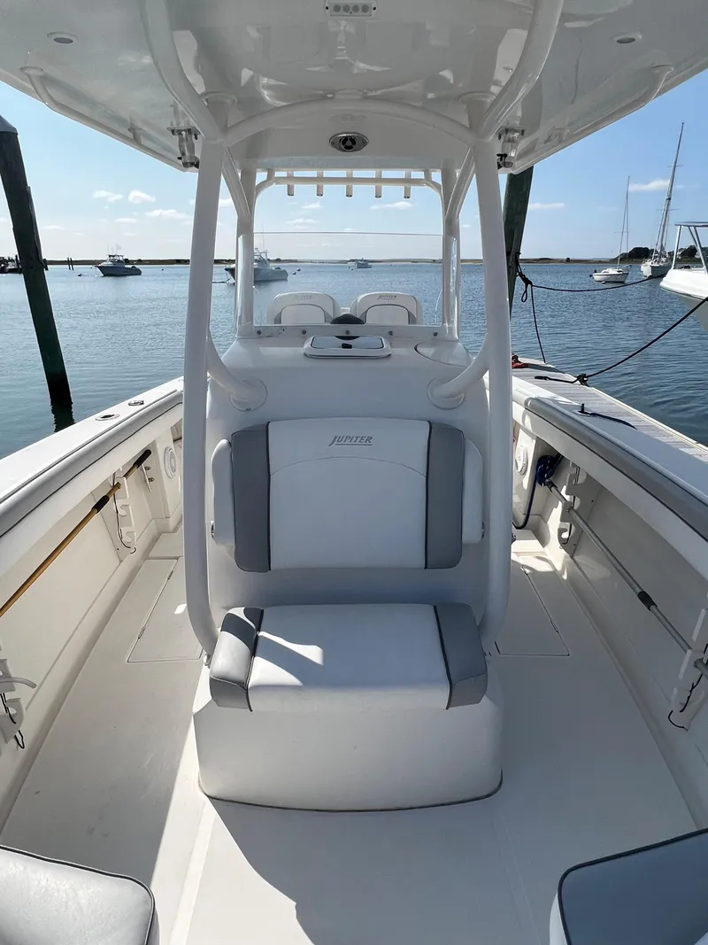 Slide: The Image of 2013 Jupiter 30 FS boat interior with seating, docked in a marina. - 26
