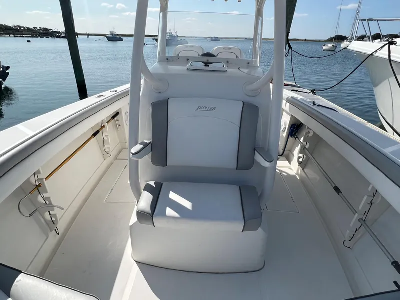 Slide: The Image of 2013 Jupiter 30 FS boat interior with seating, docked on calm water. - 27