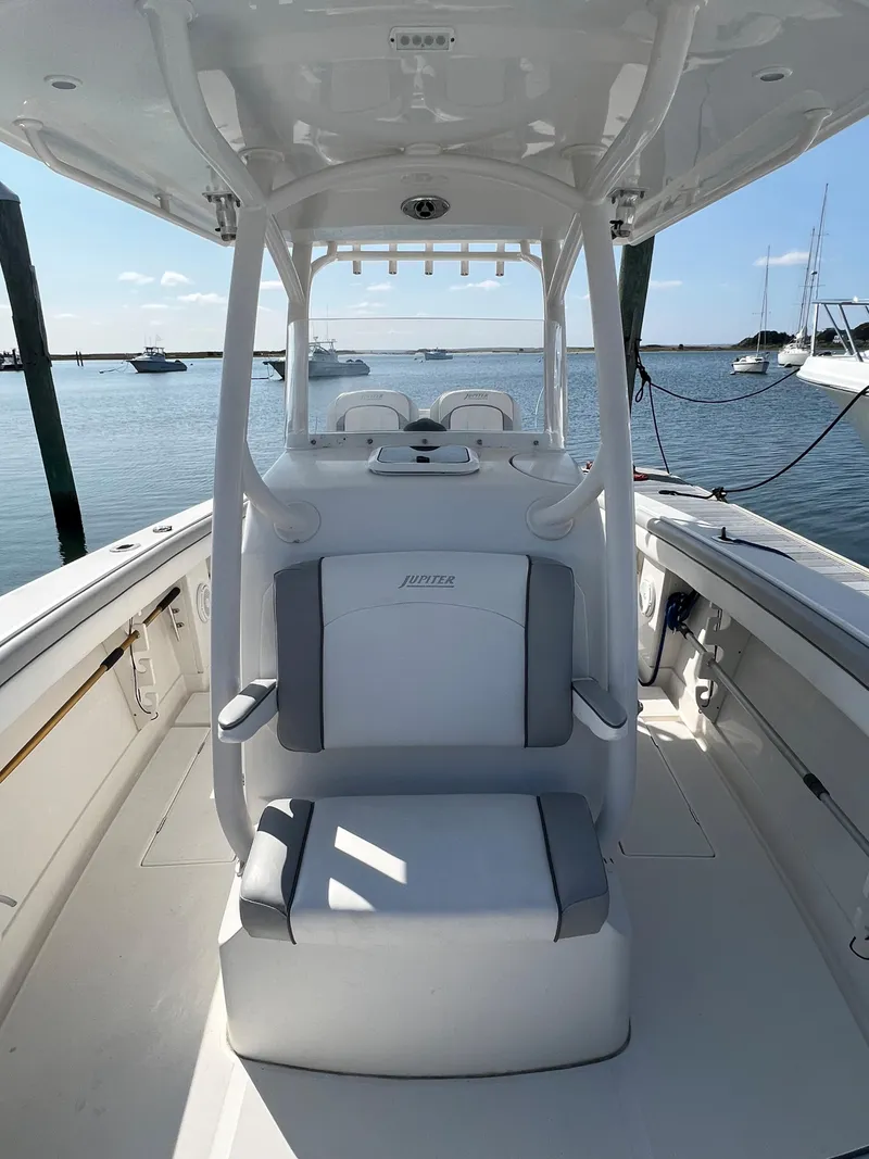 Slide: The Image of 2013 Jupiter 30 FS boat interior with seating, docked in a marina. - 28